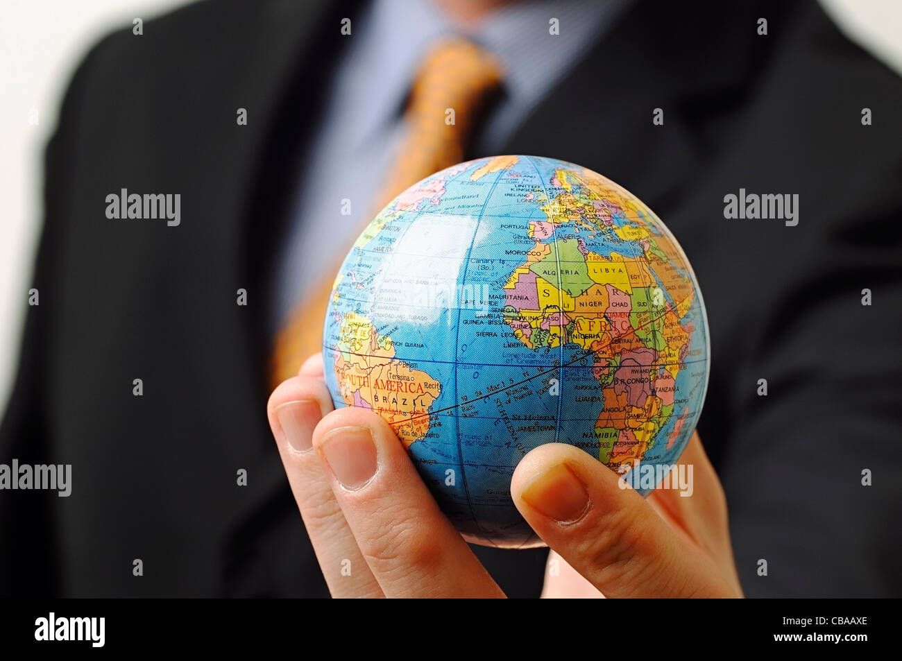 Businessman Holding a Globe in His Hand, Close Up. Stock Photo