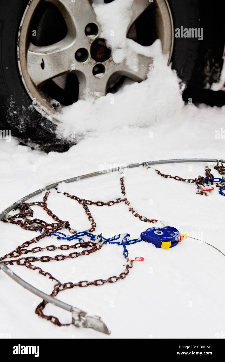 An illustrative photo of snow chains prepared to be mounted on the tire