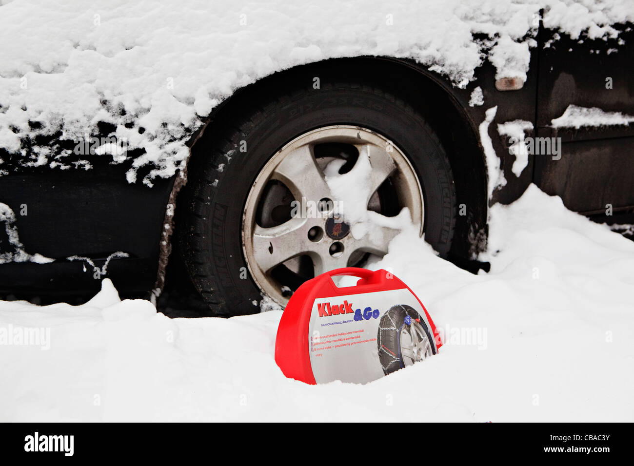 An illustrative photo of snow chains prepared to be mounted on the tire