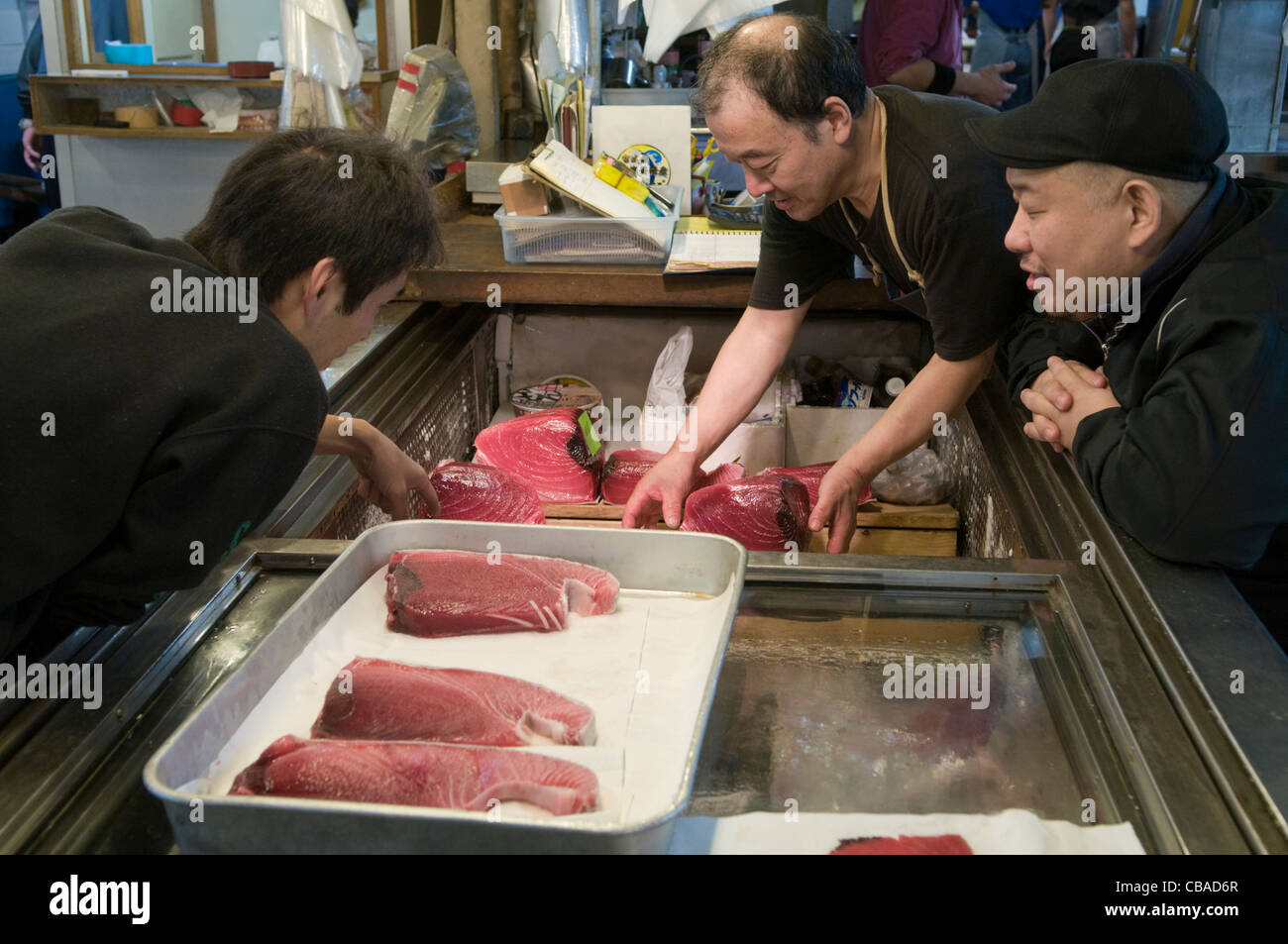 Inspecting fresh tuna for sale at the Tsukiji Fish Market Tokyo Japan Stock Photo