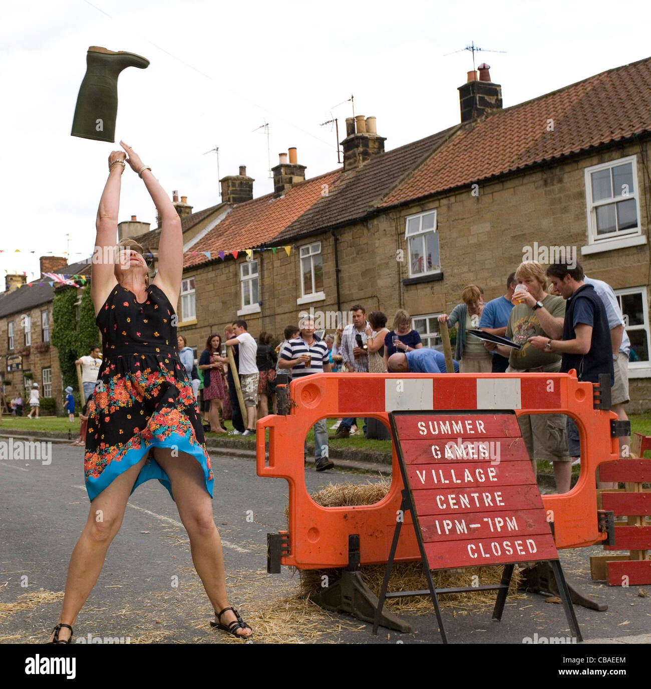 Lady Tossing Welly during Osmotherley Village Summer Games North Yorkshire England Stock Photo