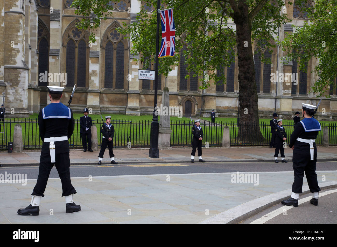 Members of the British Royal Navy and Metropolitan Police stand guard