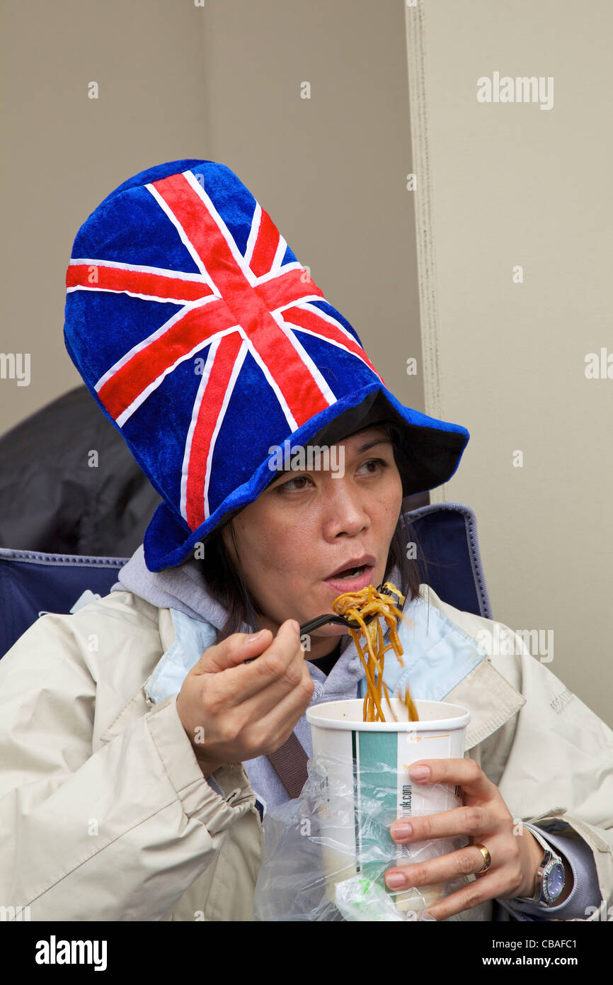 Foreign visitor enjoys noodles during marriage of Prince William to Kate Middleton, 29th April 2011, London, England, GB, Stock Photo