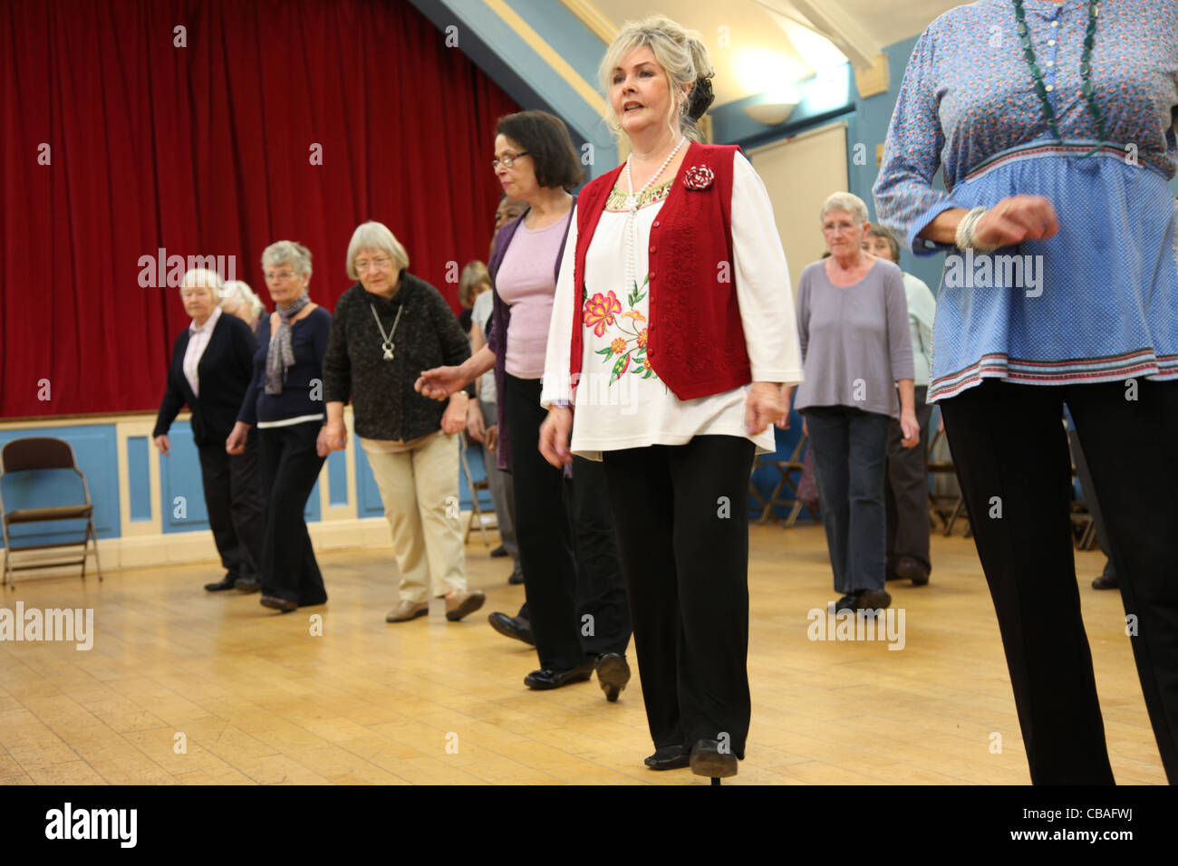 Women linedancing in a community hall Stock Photo