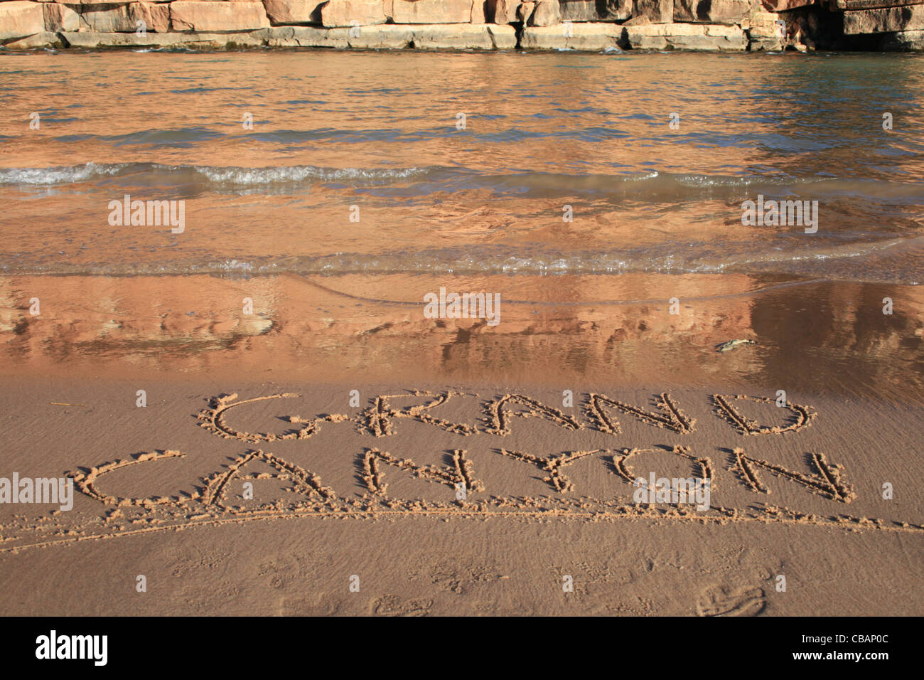 Grand Canyon written in the sand on a Colorado River bank beach Stock Photo