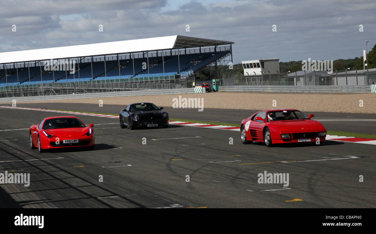 RED FERRARI 458 ITALIA BLACK 599 & 348 CARS SILVERSTONE CIRCUIT ENGLAND 14 September 2011 Stock Photo