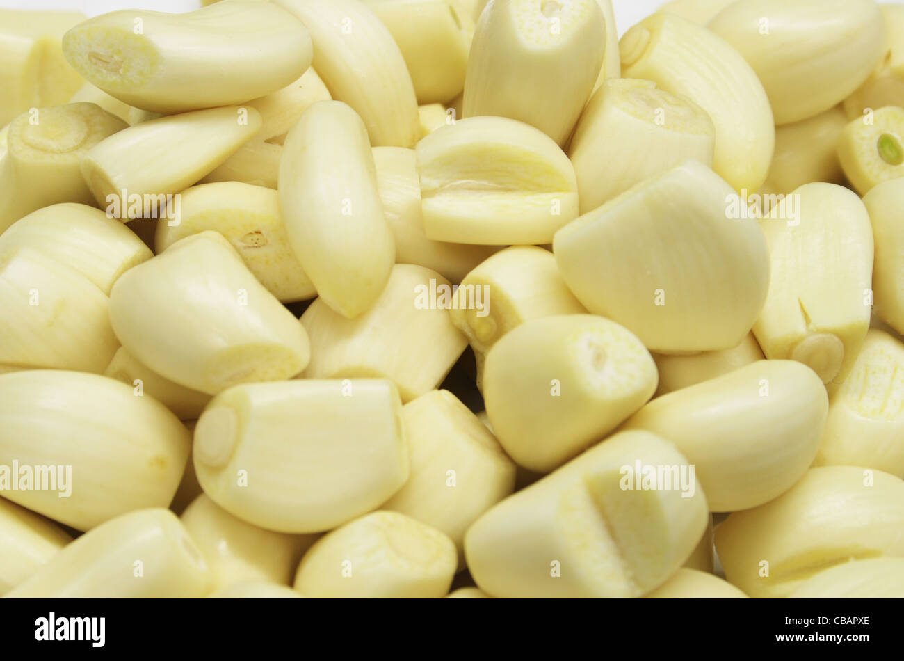 background of trimmed peeled garlic cloves Stock Photo