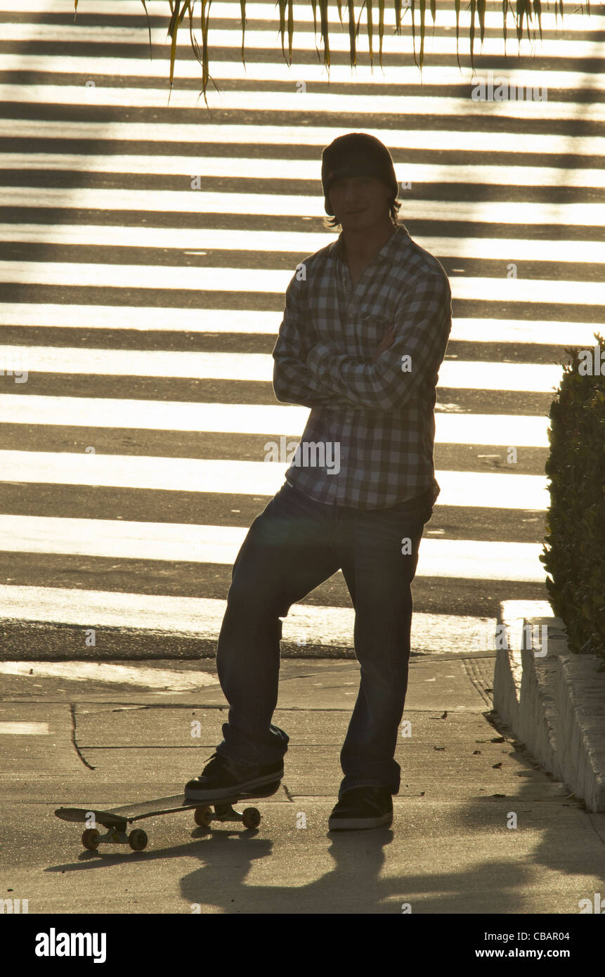 A silhouette portrait of a skateboarder street athlete. Stock Photo