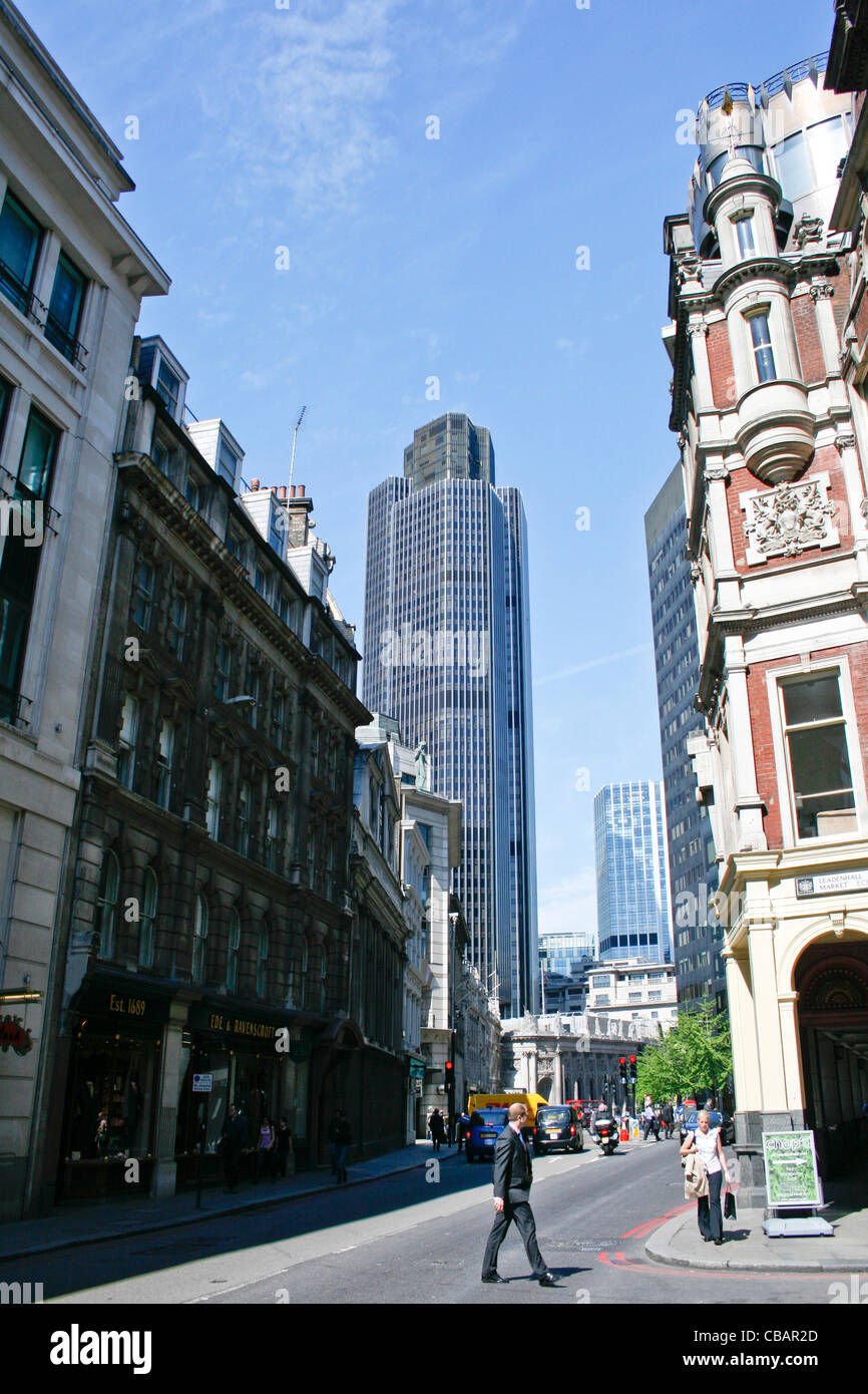A London Street scene with commuters and the Natwest Tower Building in the background. Stock Photo
