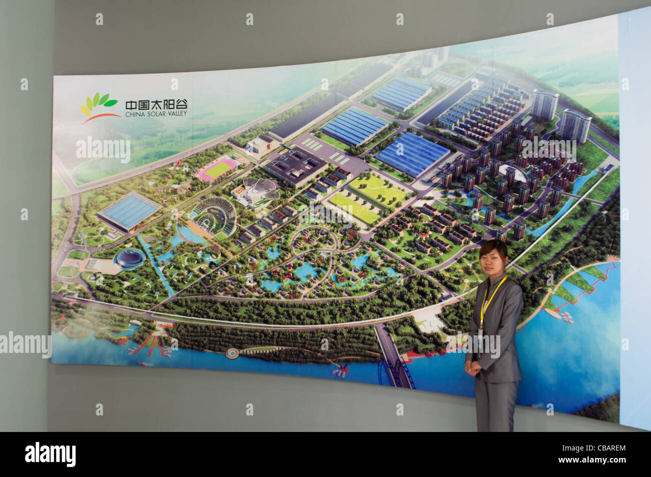 A hostess in front of the big billboard with the project of the China Solar Valley. Dezhou, Shandong, China Stock Photo