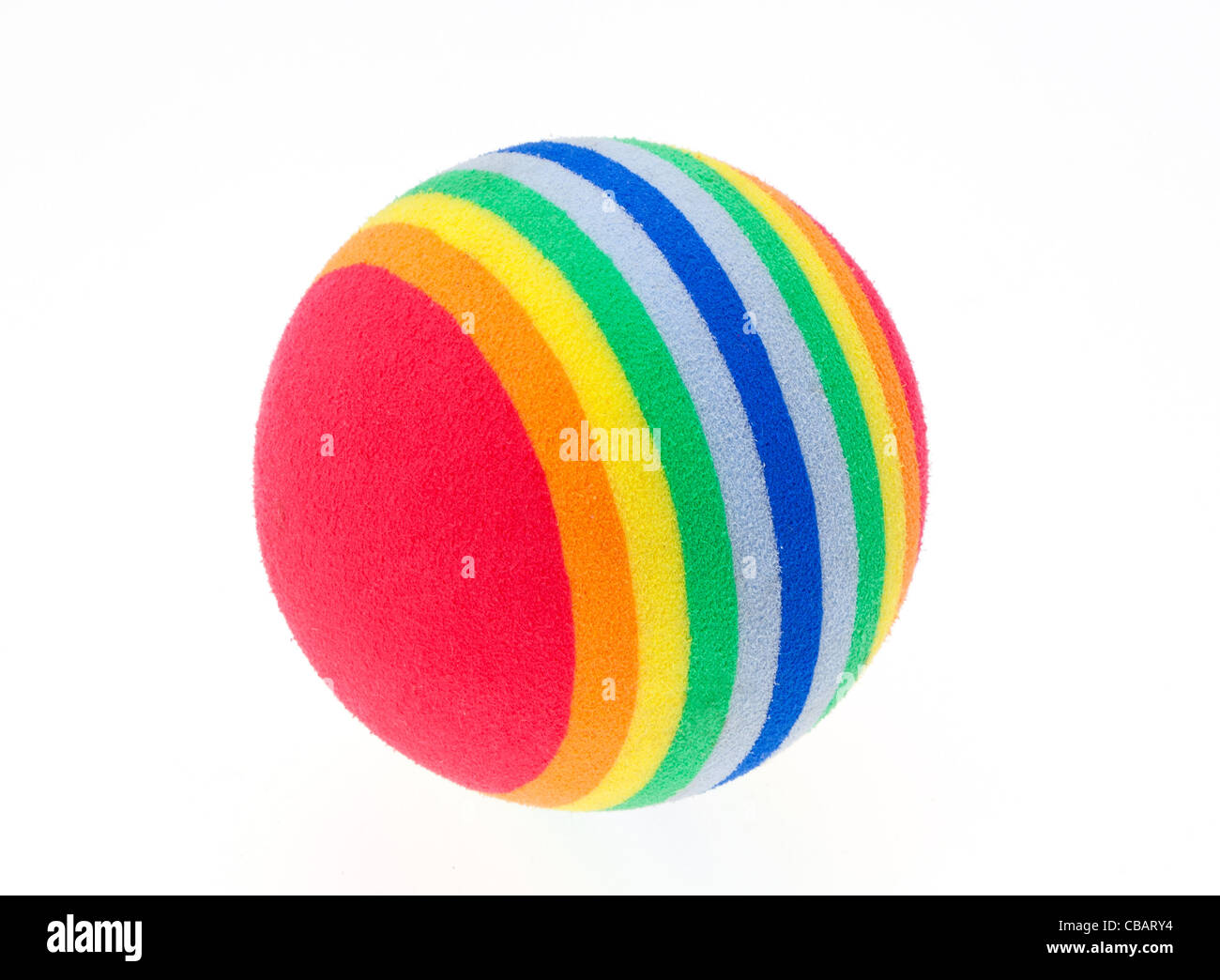 Close-up of a child's multi-coloured soft play ball isolated against a white background. Stock Photo