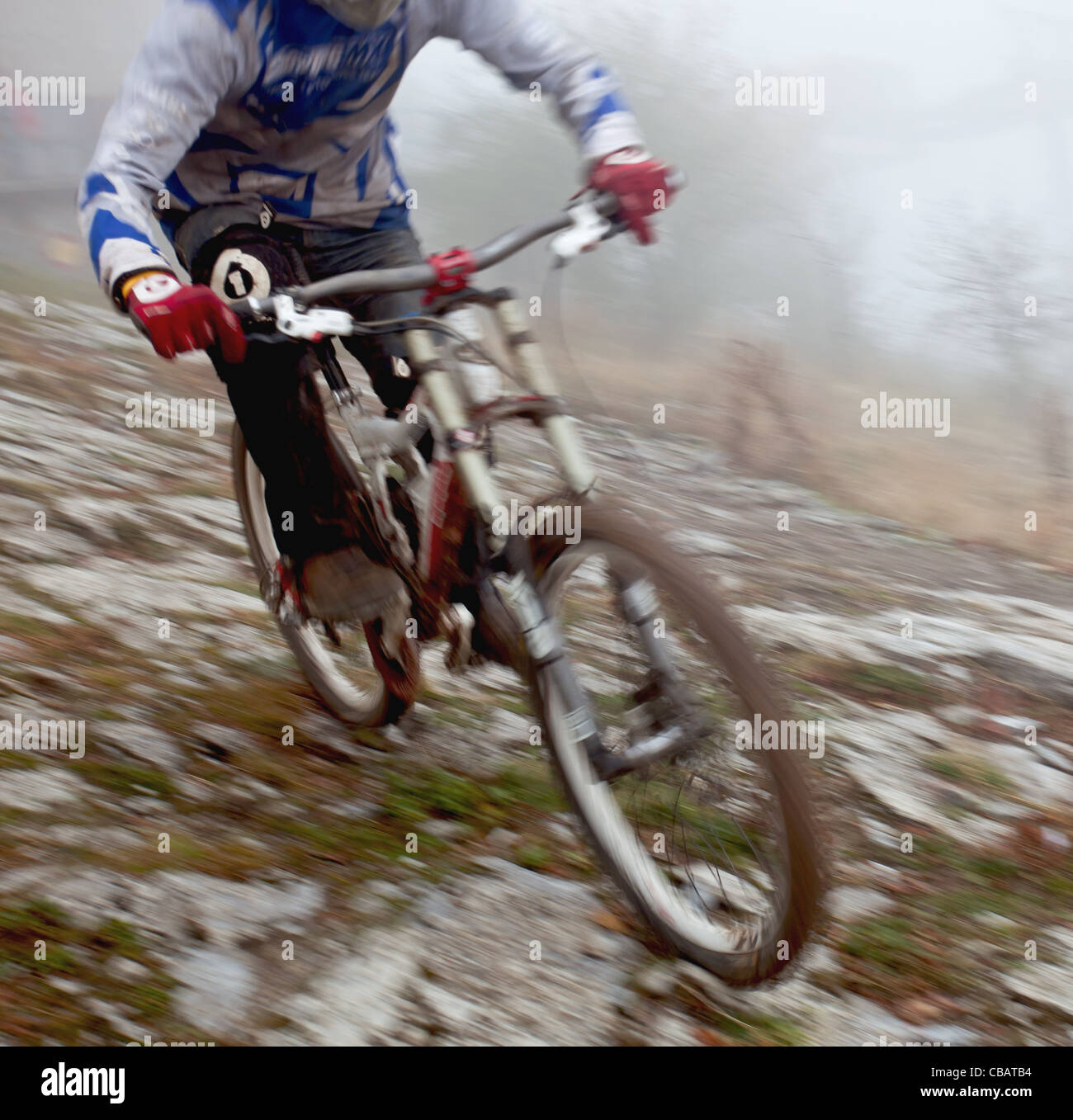 A young man riding a mountain bike downhill style Stock Photo - Alamy