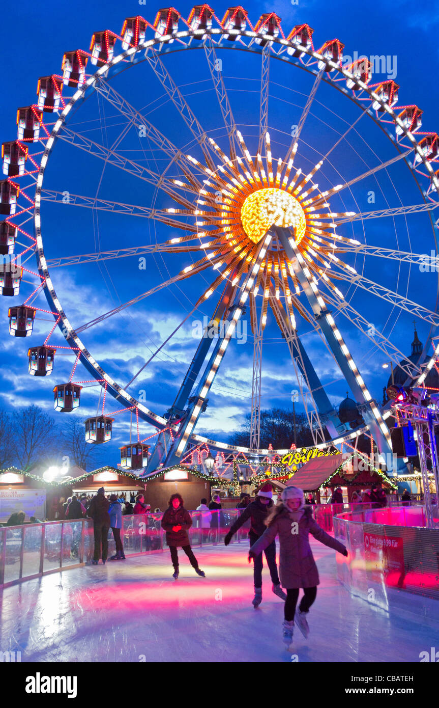 Traditional Christmas market with funfair and ice rink at