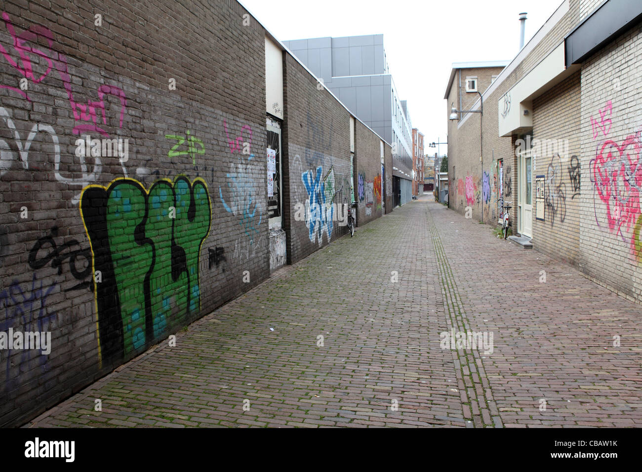 An alley tagged with graffiti in Breda, the Netherlands. Stock Photo