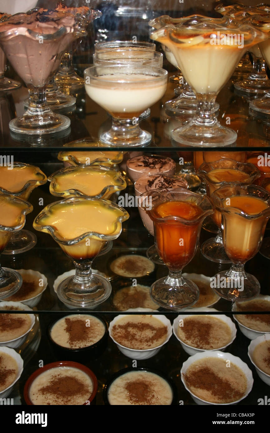 Dishes of desserts on sale in restaurant. Stock Photo