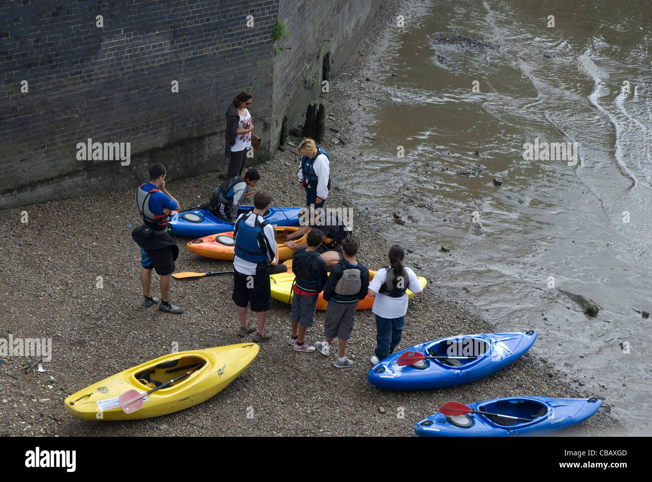 Canoeists on the shore River Thames Strand on the  Green West London Stock Photo