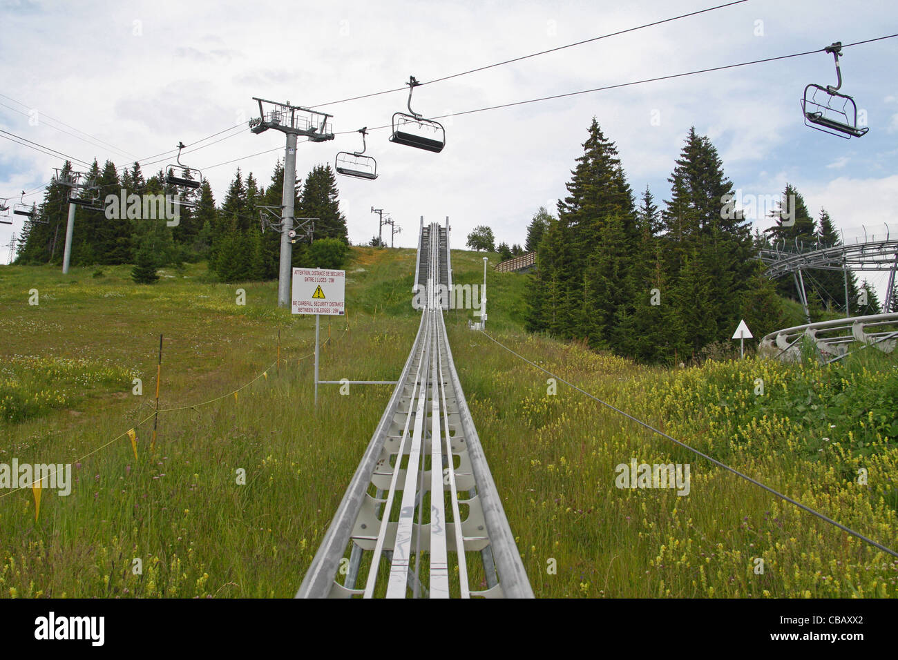 Les Saisies, Savoie (Savoy), France, French Alps. Summer luge (luge d'ete) and ski lift Stock Photo