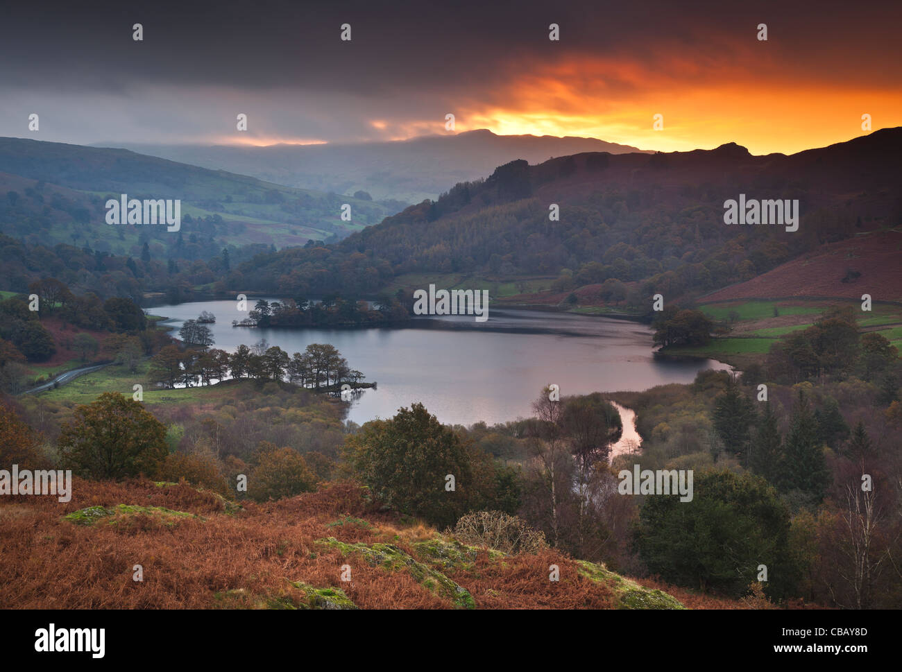 Fiery sunrise over Rydal Water seen from White Moss Common in Autumn, near Ambleside, Lake District, Cumbria, UK Stock Photo