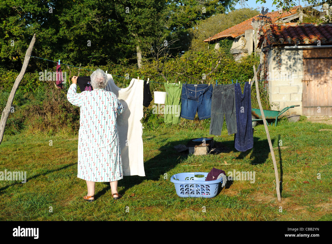 stock-photo-of-a-woman-hanging-out-the-washing-CBB2YN.jpg