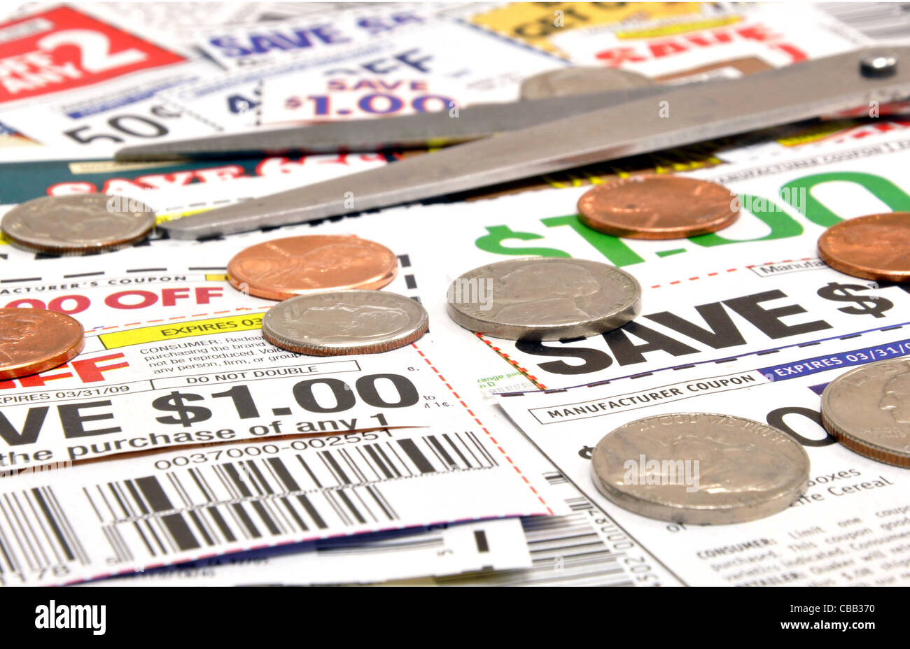 Clipping coupons to save at the grocery store Stock Photo Alamy