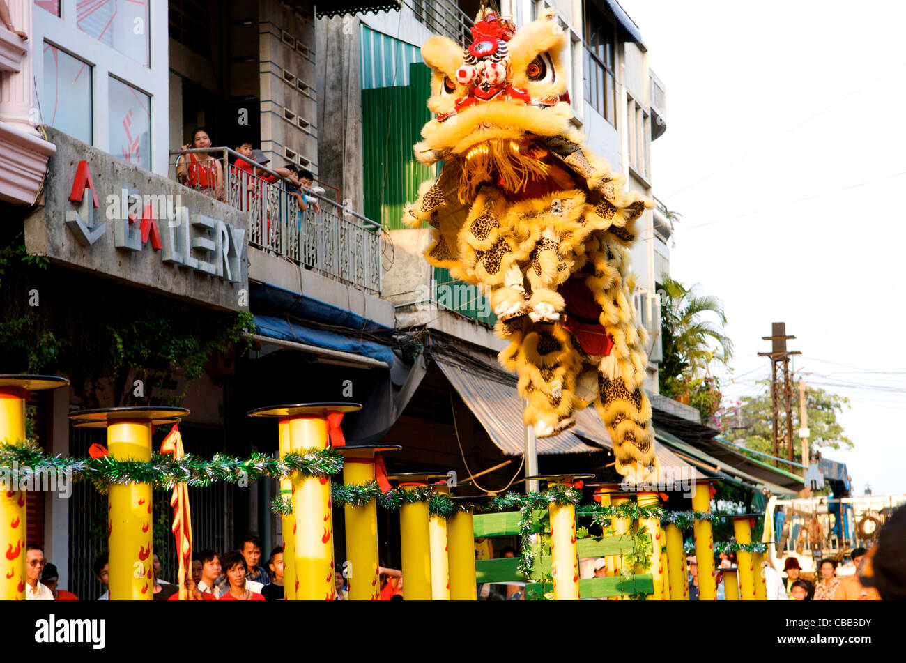 Lion jumps from pole to pole during traditional Lion dancing, Chinese