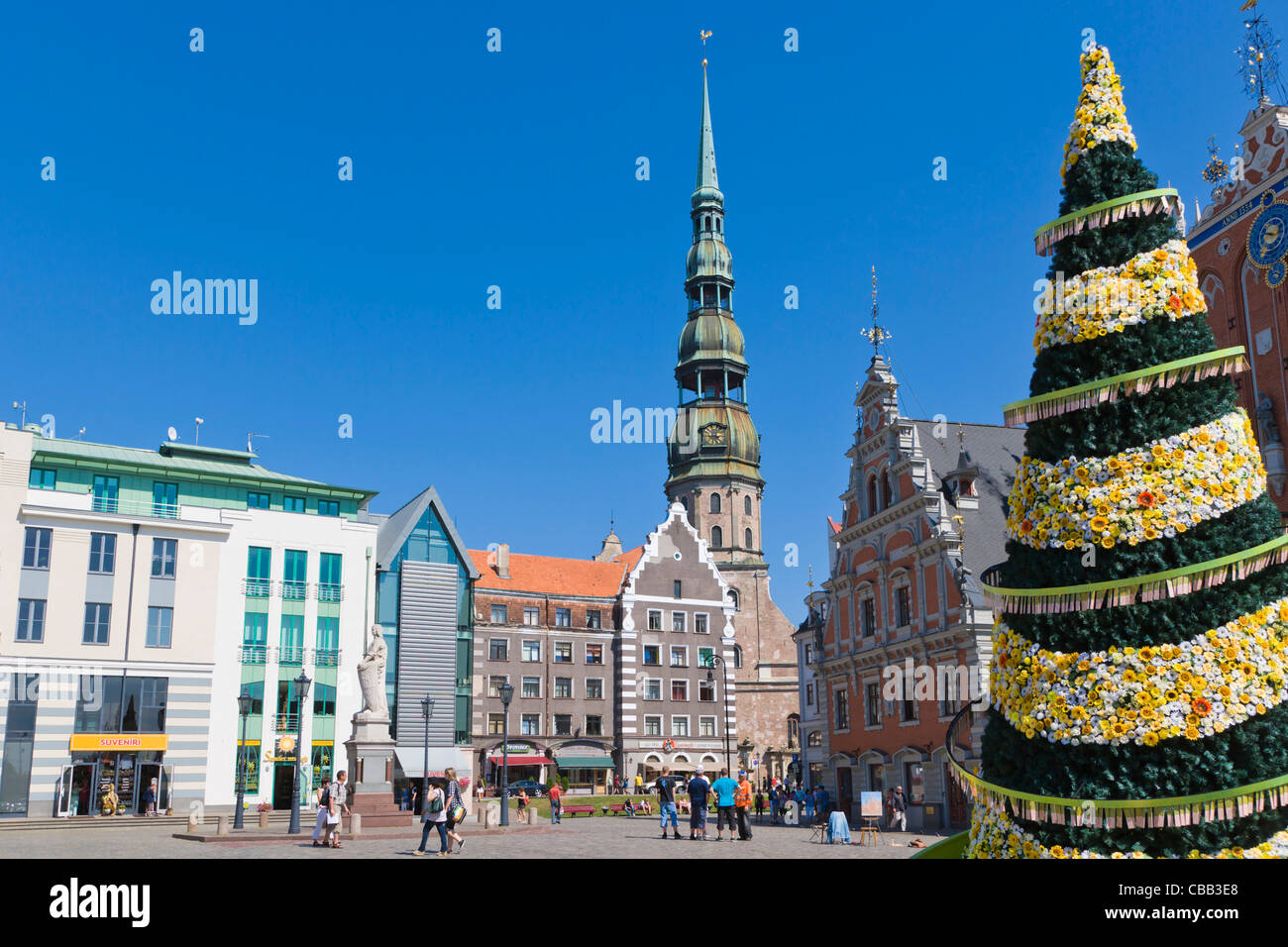 The spire of the St Peter's Church, House of Blackheads, 500th jubilee Christmas Tree, Town Hall Square, Riga, Latvia Stock Photo