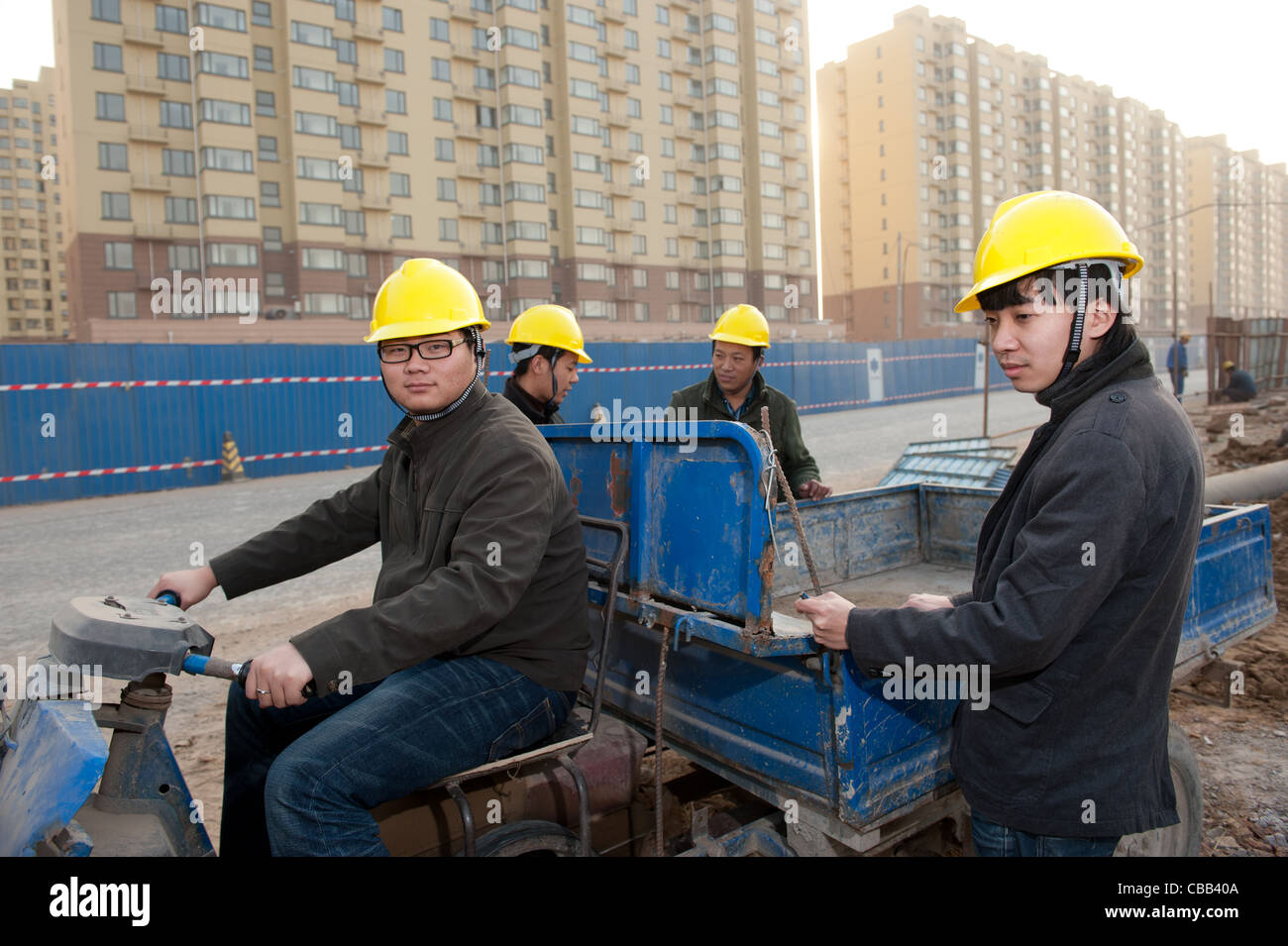 Construction workers with apartment buildings in the background Stock Photo