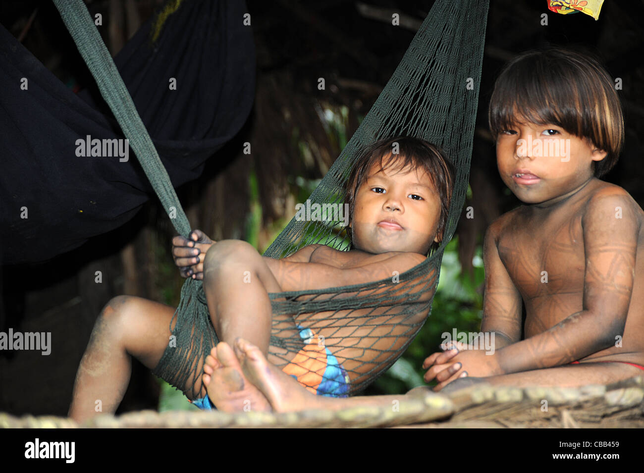Embera indian brothers in hammock at the Embera Puru indigenous community, Panama Stock Photo