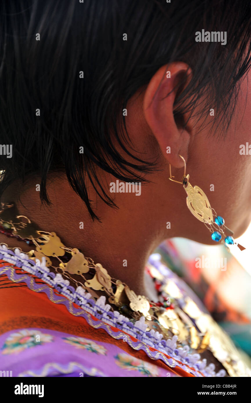 Guna indian woman wearing her typical gold jewelry at Corbisky island in Guna Yala, Panama. Stock Photo