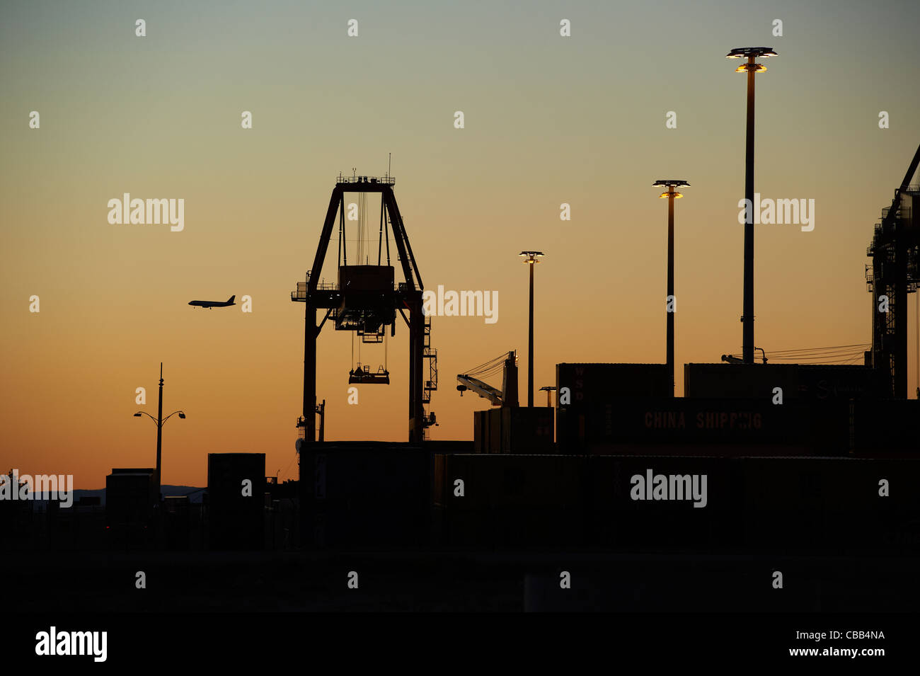 Silhouetted shipping terminal Stock Photo