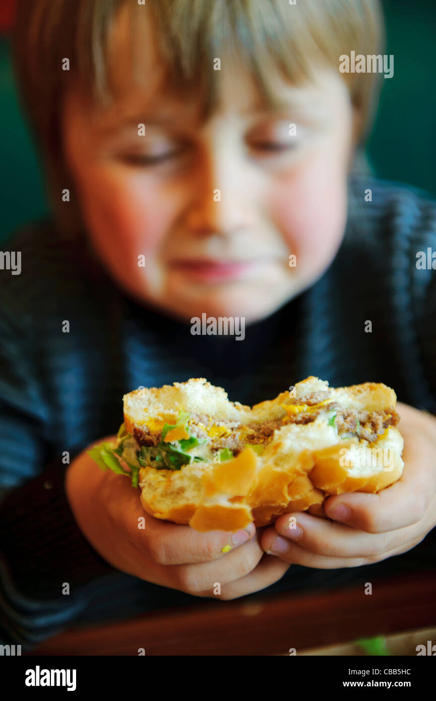 Stock photo of an 11 year old boy eating a burger Stock Photo Alamy