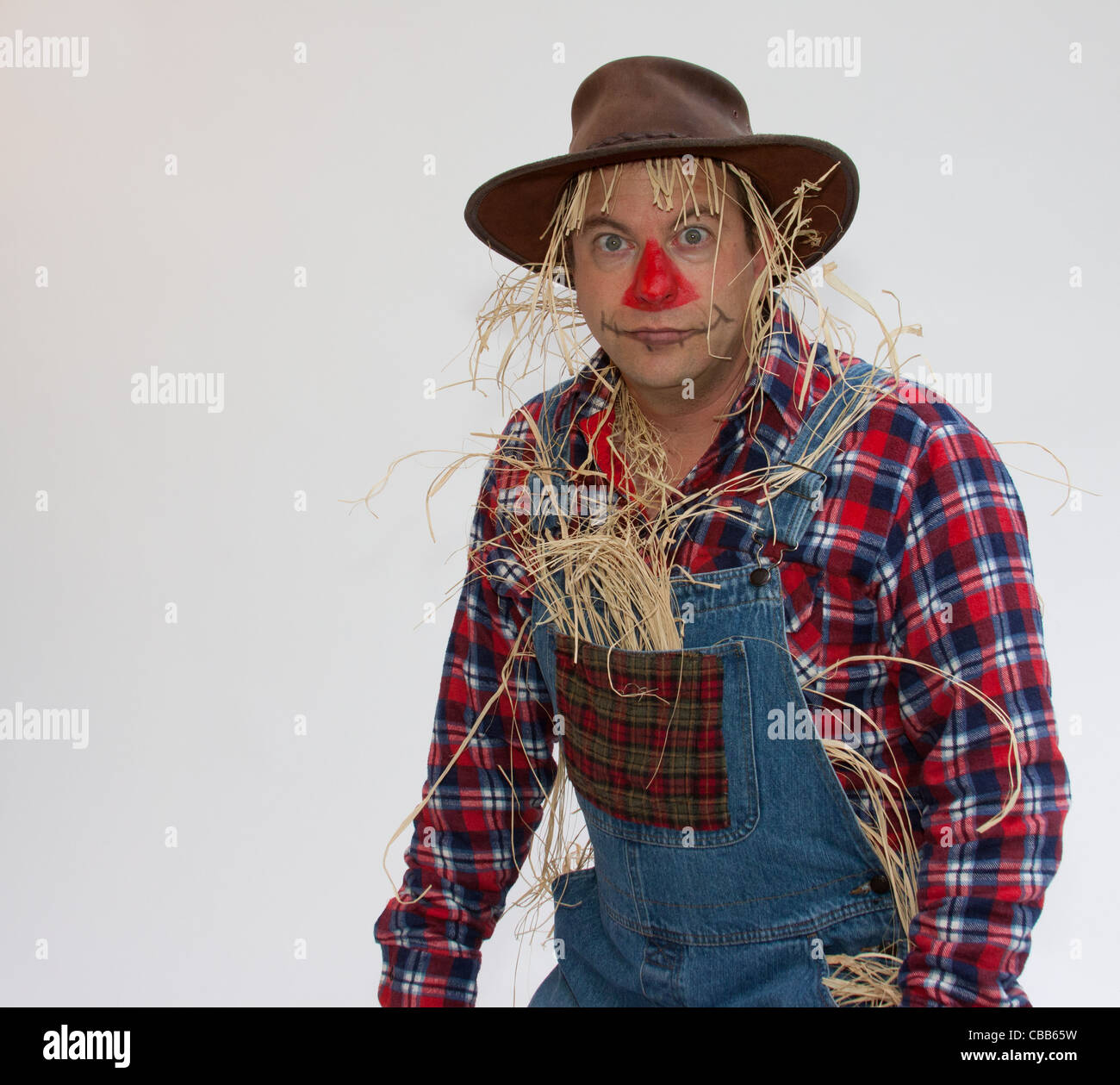 Human Scarecrow making faces or trying to scare off the crows. Stock Photo