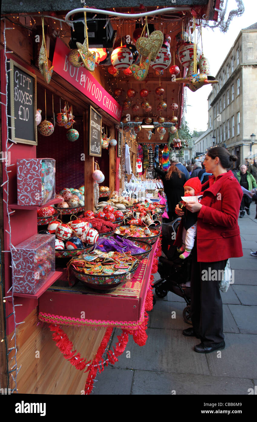 Christmas market stall with shoppers at Bath Christmas Market, Bath
