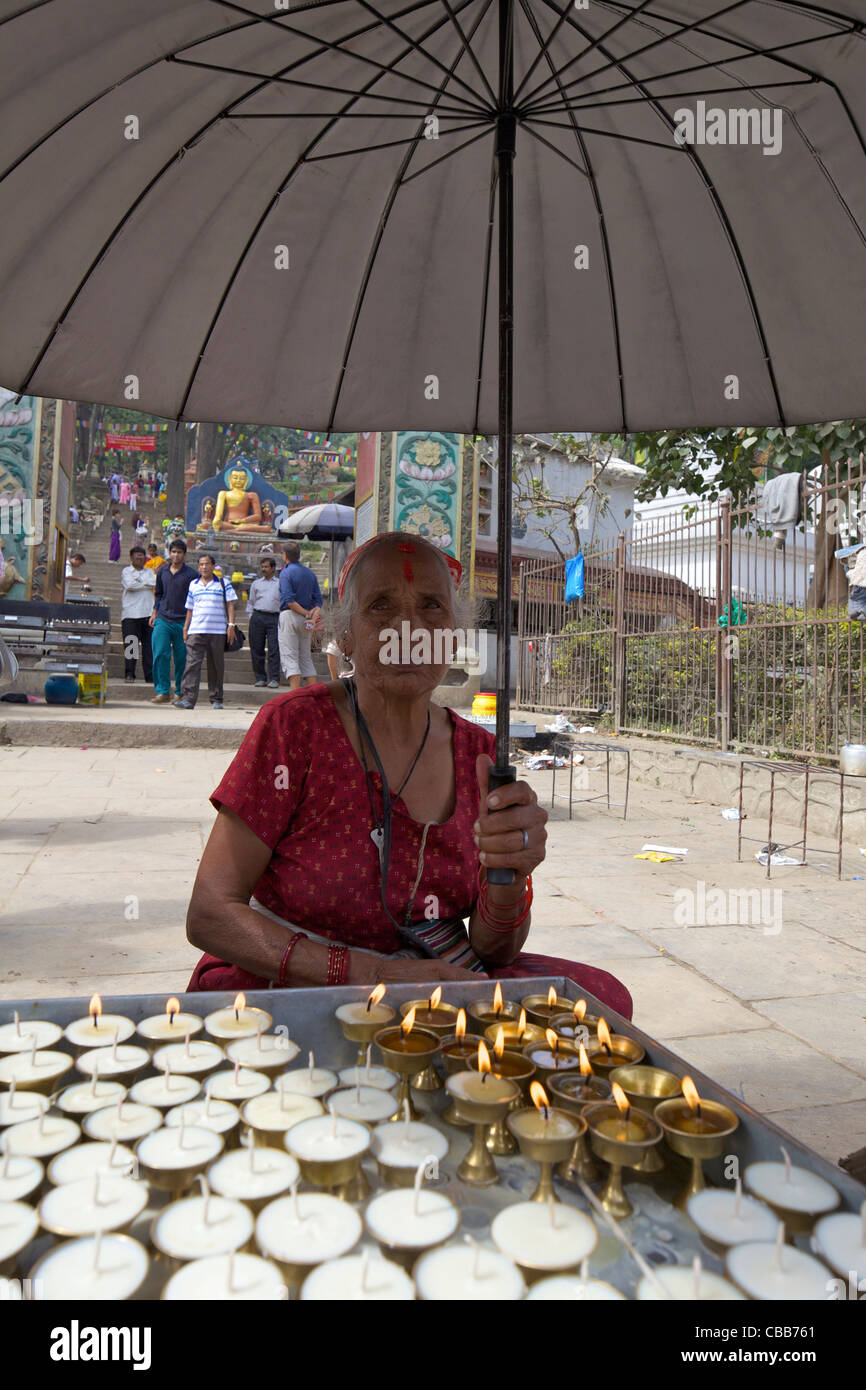 Old lady selling candles, entrance to Swayambhunath Stupa, Monkey Temple, UNESCO World Heritage Site, Kathmandu, Nepal, Asia Stock Photo