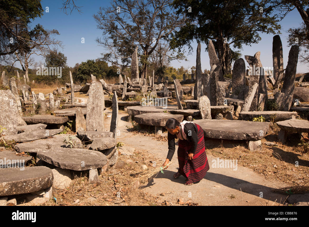 India, Meghalaya, Jaintia Hills, Nartiang Megaliths, woman cleaner sweeping paths between stone monoliths Stock Photo