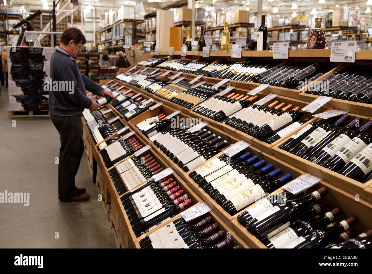 A man buying wine in a Costco discount warehouse store, lakeside, UK Stock Photo