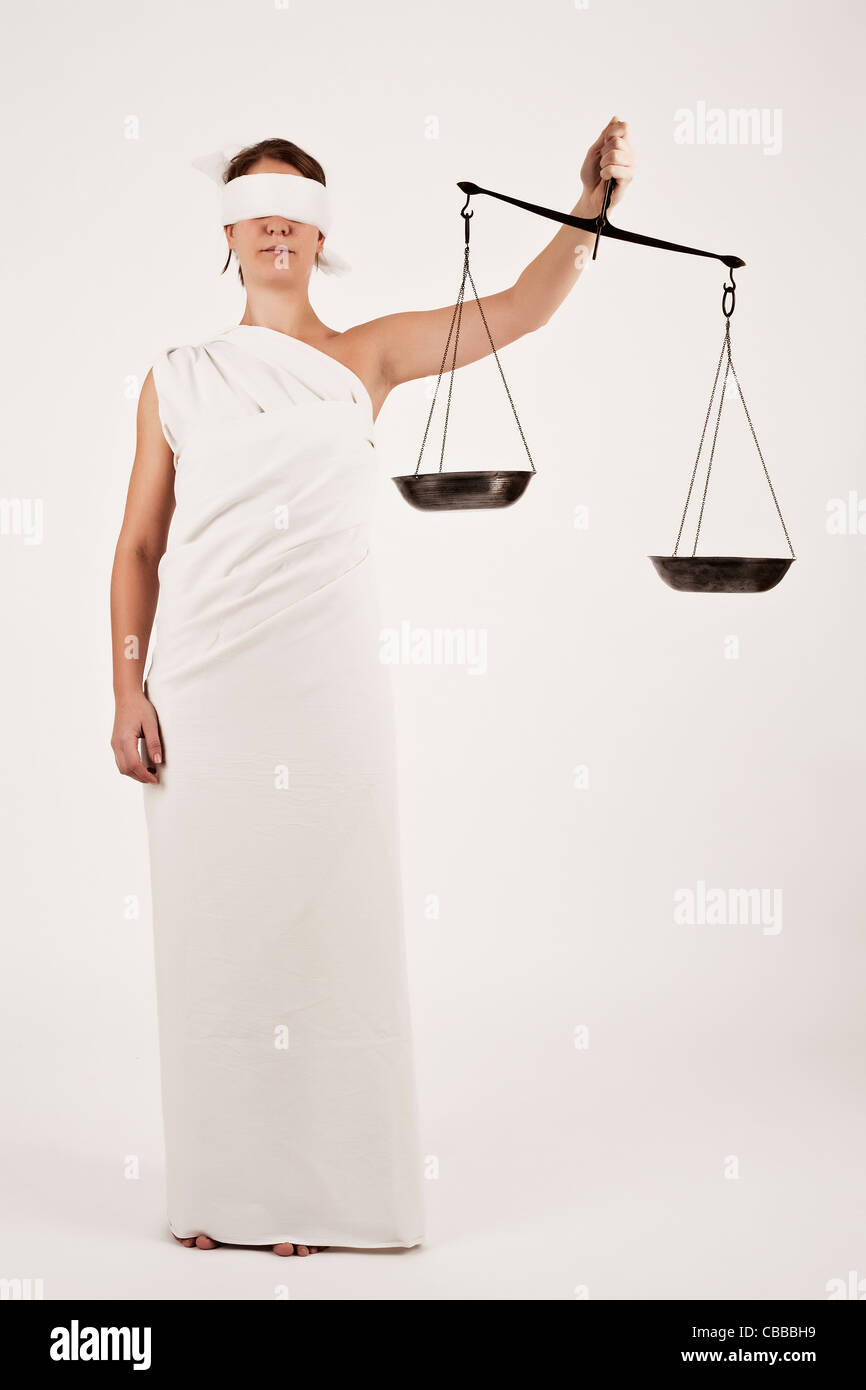 An illustrative photo of female model dressed as Justitia, Roman Goddess of Justice and the Legal System, in her hands she Stock Photo