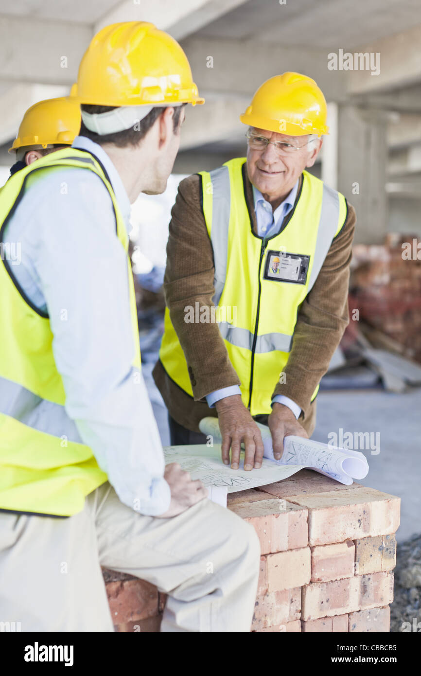 Construction workers reading blueprints Stock Photo Alamy