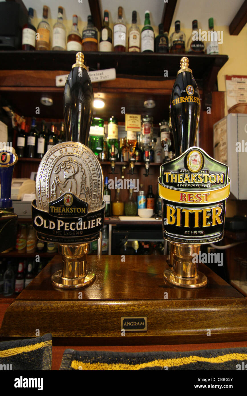 Theakstons Old Peculiar and Best Bitter handpumps in a traditional yorkshire dales country pub Stock Photo