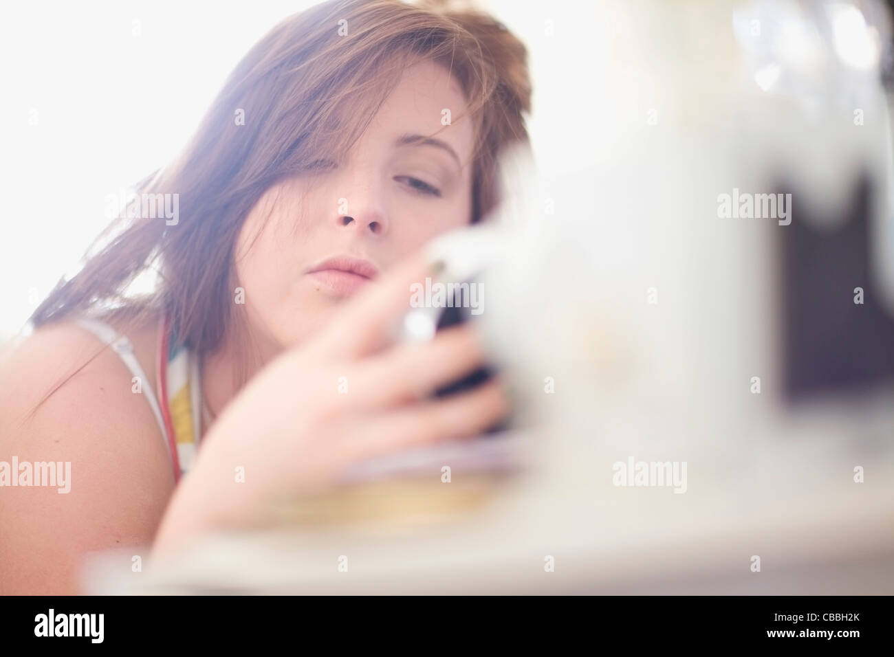 Teenage girl checking alarm clock Stock Photo Alamy
