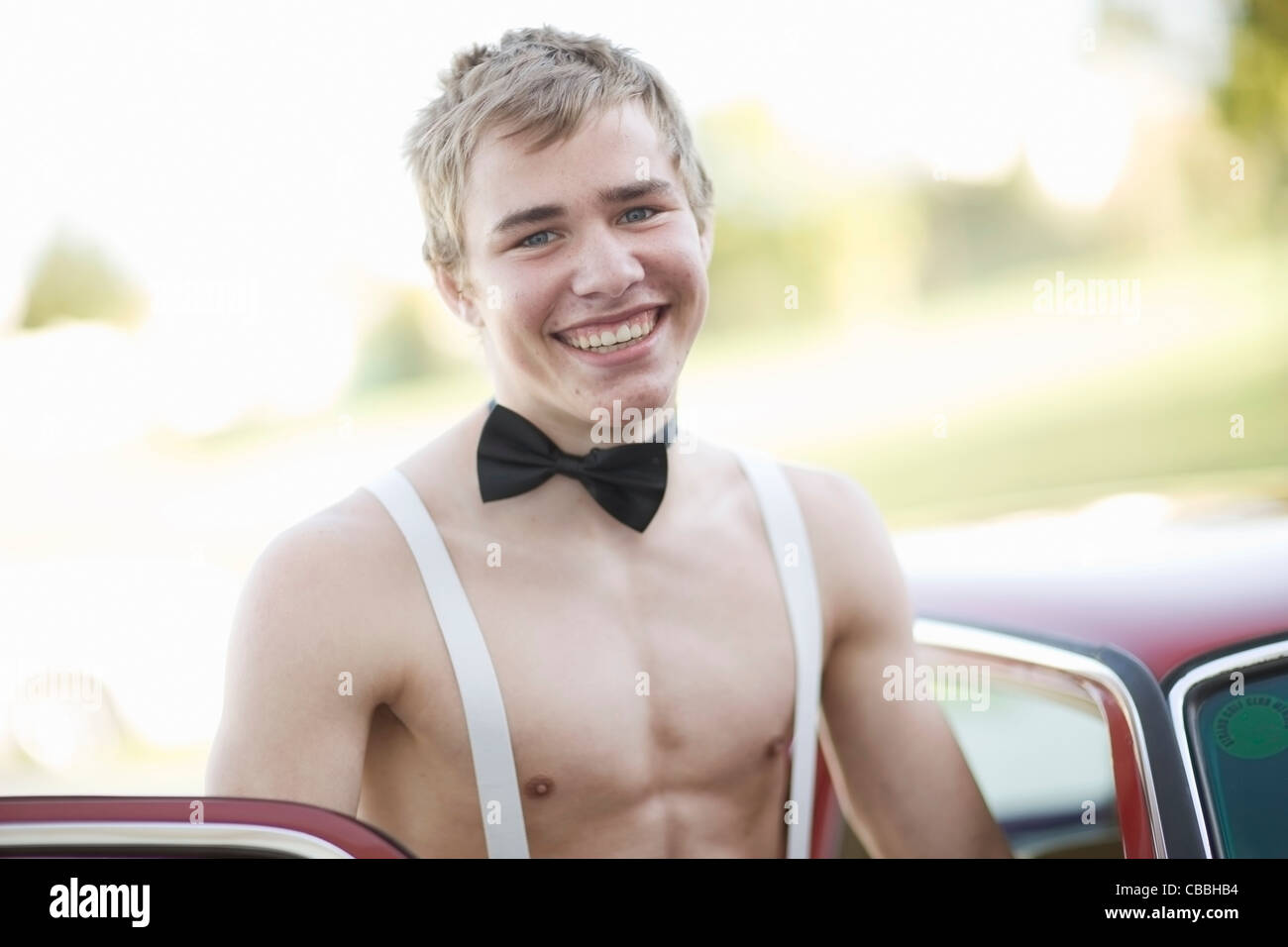 Teenage boy in bow tie and suspenders Stock Photo Alamy