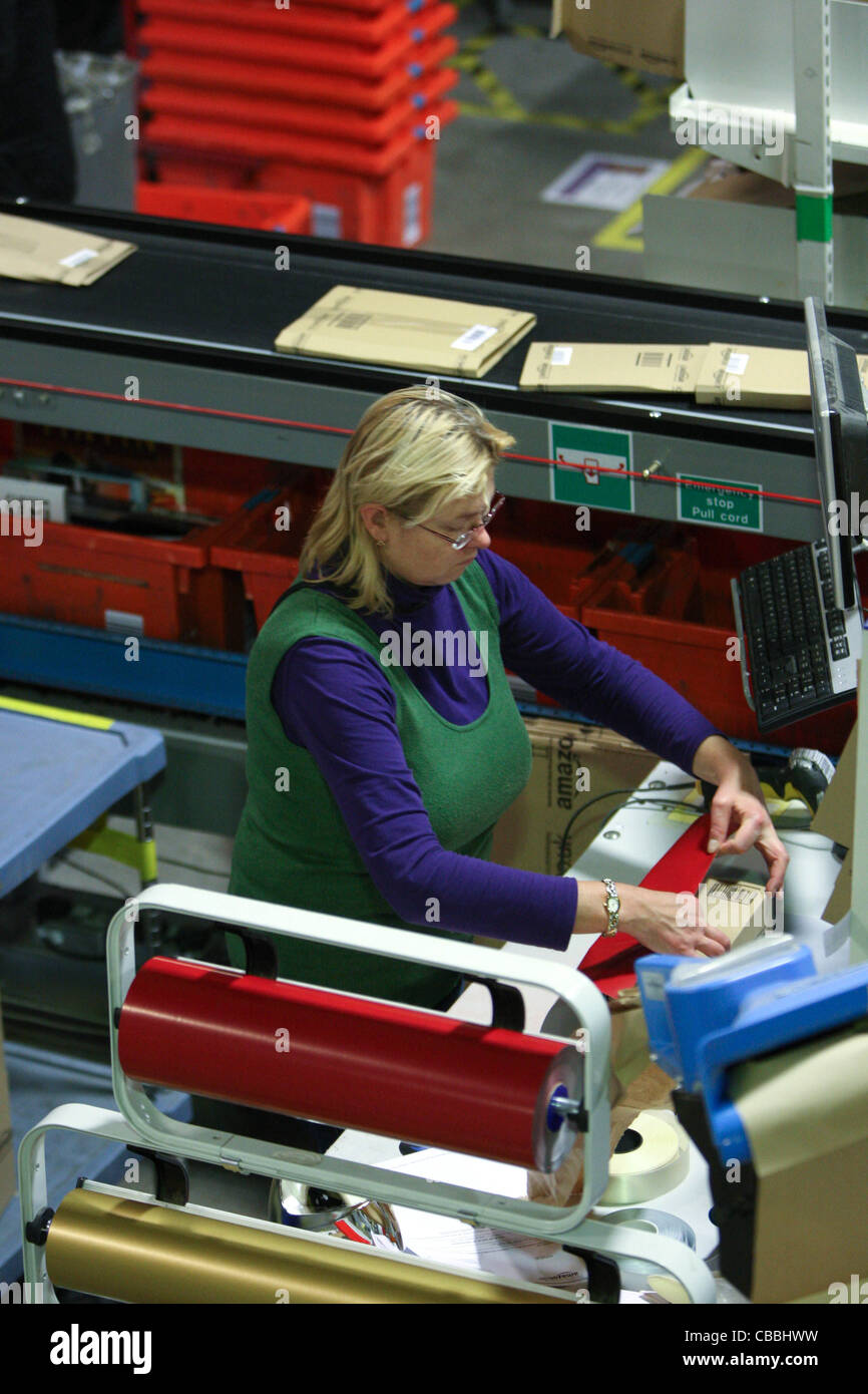 WORKERS SORTING CHRISTMAS PRESENTS AT THE AMAZON WAREHOUSE IN MILTON