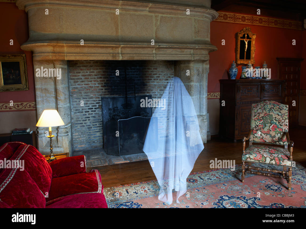 Ghost floating in ornate living room Stock Photo