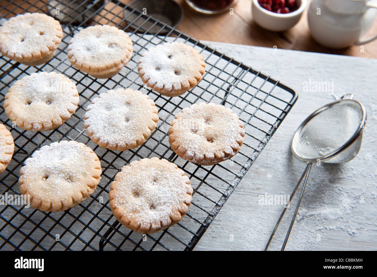 Freshly Baked Mince Pies on a Cooling Rack and Been Sprinkled With Icing Sugar Stock Photo