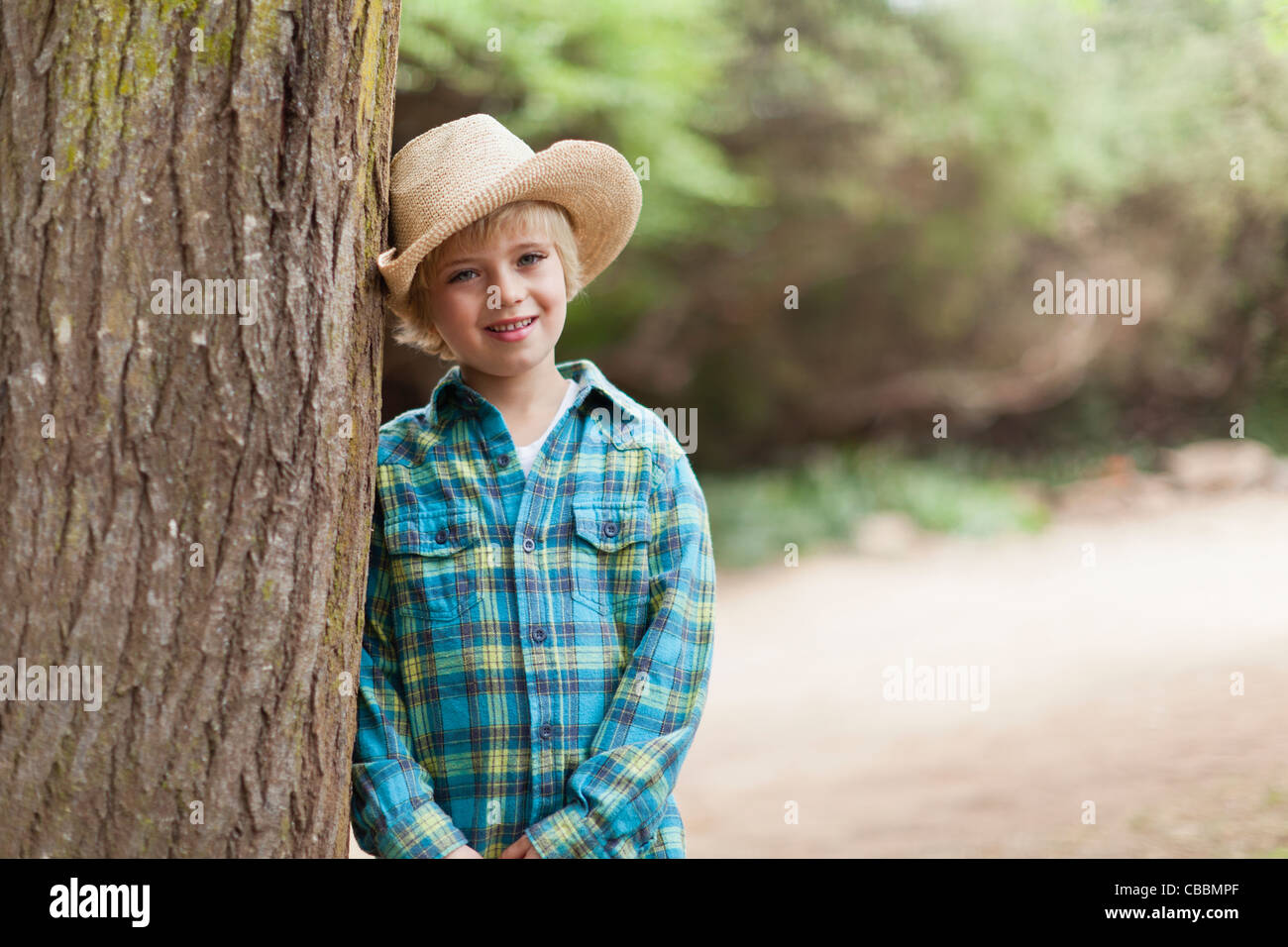 Boy wearing cowboy hat outdoors Stock Photo