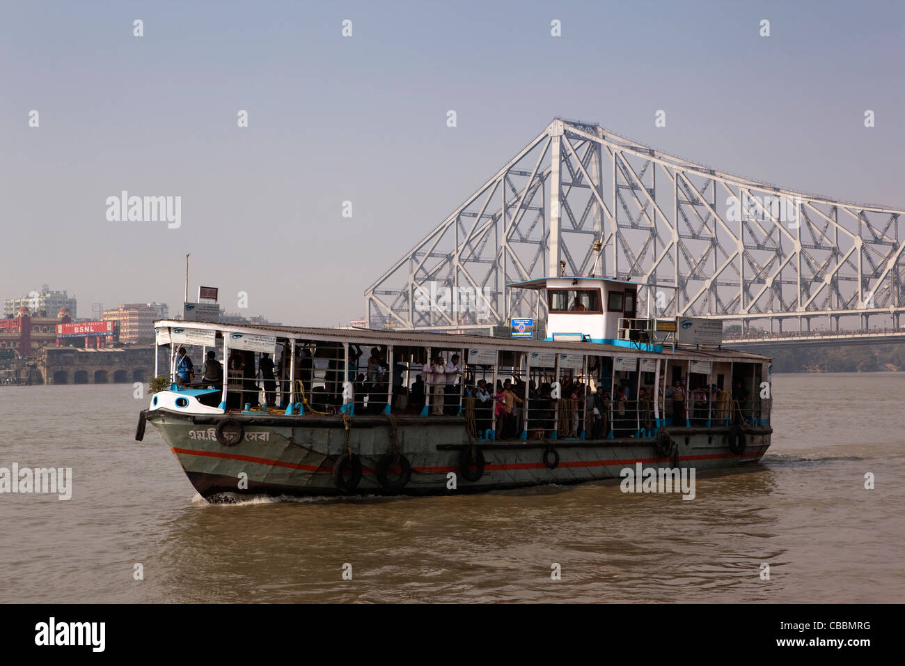 India, West Bengal, Kolkata, Armenian Ghat, Hooghly river ferry crossing below Howrah bridge Stock Photo