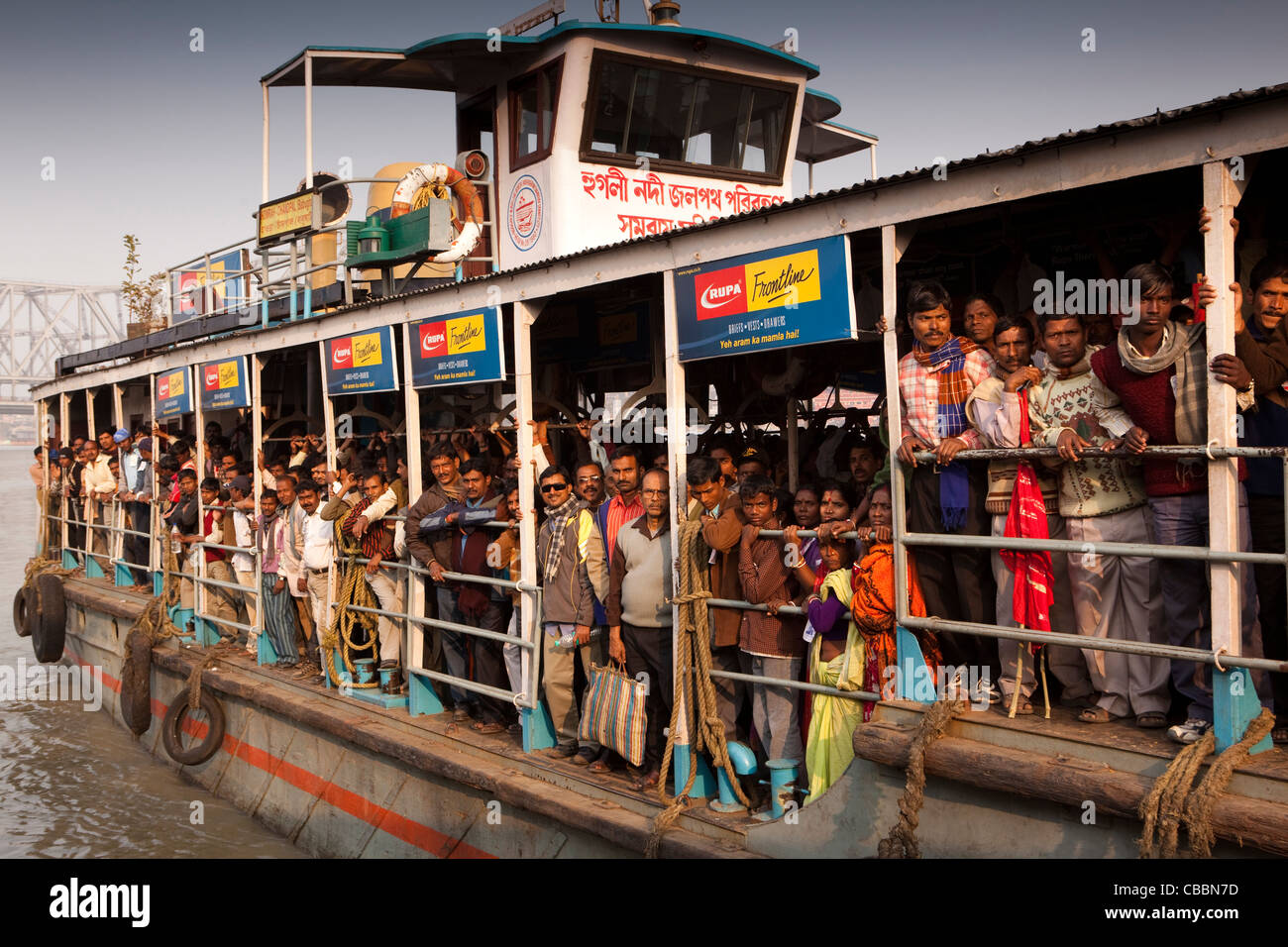 India, West Bengal, Kolkata, Howrah Ghat, passengers on Hooghly river ferry crossing below Howrah bridge Stock Photo