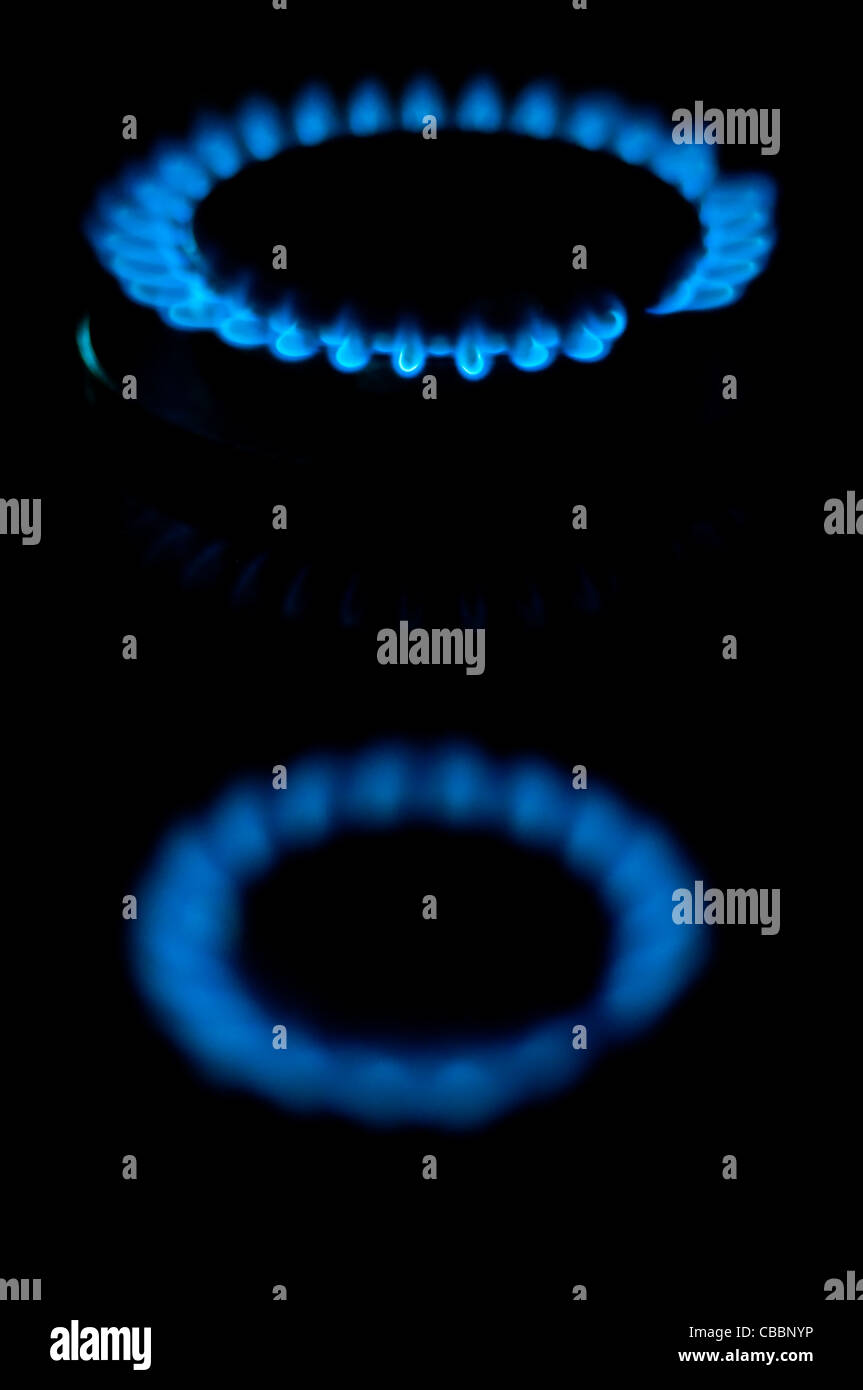 kitchen gas burning with blue flame isolated on black background Stock