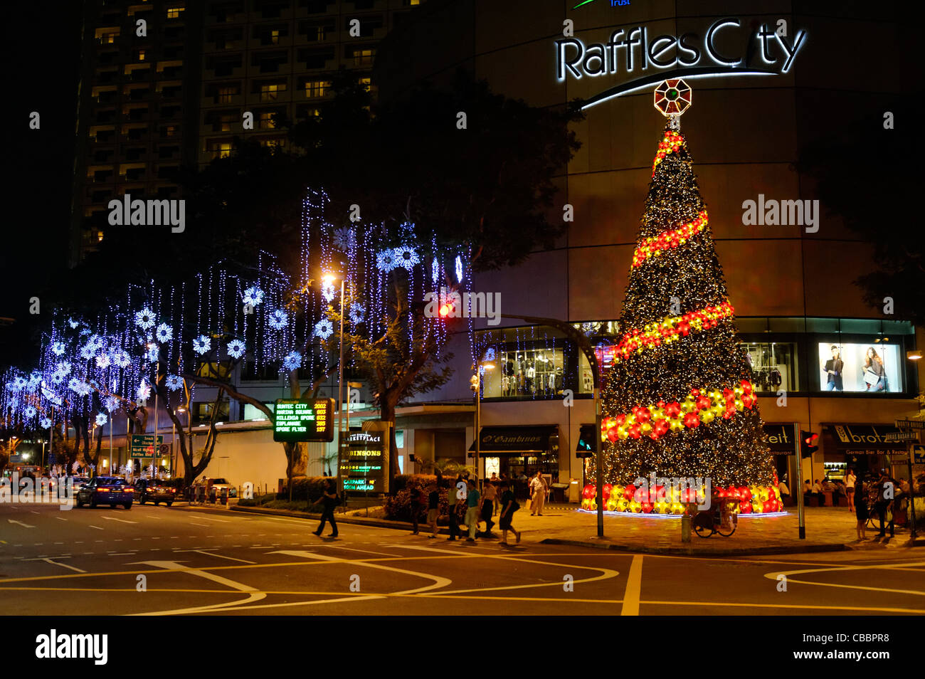 Christmas tree and lights in Singapore outside Raffles City Mall. Stock Photo