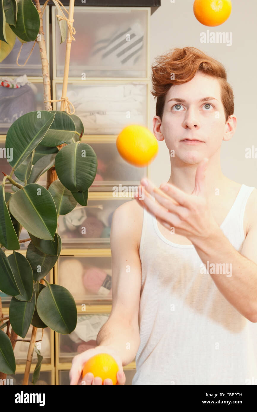 Man juggling fruit Stock Photo